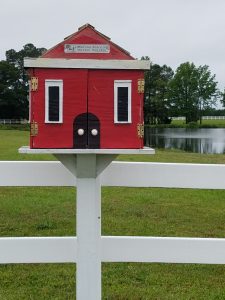 Image: A Little Free Library in the image of a red school house