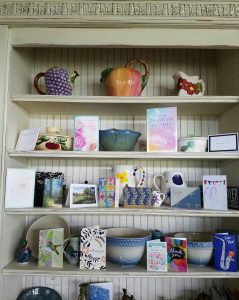 Image: Kitchen hutch filled with note cards and pottery